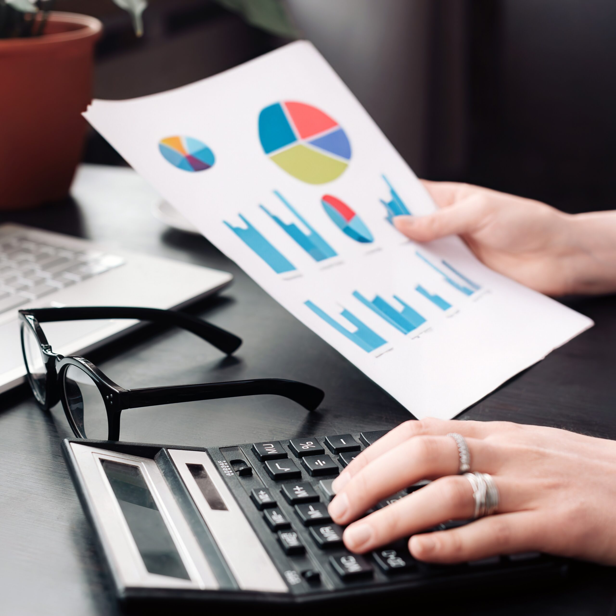 Focused Businesswoman: Analyzing Financial Budget and Calculating Finance Report in Office, Proficiently Engaged in Finance, Accounting, and Financial Analysis using Calculator and Document